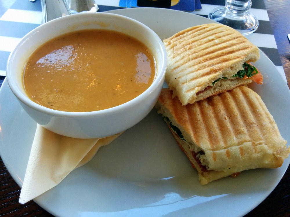 Parma ham, rocket, brie and tomato panini with vegetable broth.